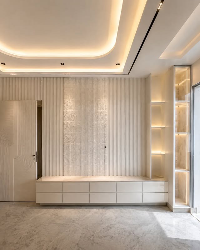 Finished bedroom wall unit with cove lighting and marble flooring